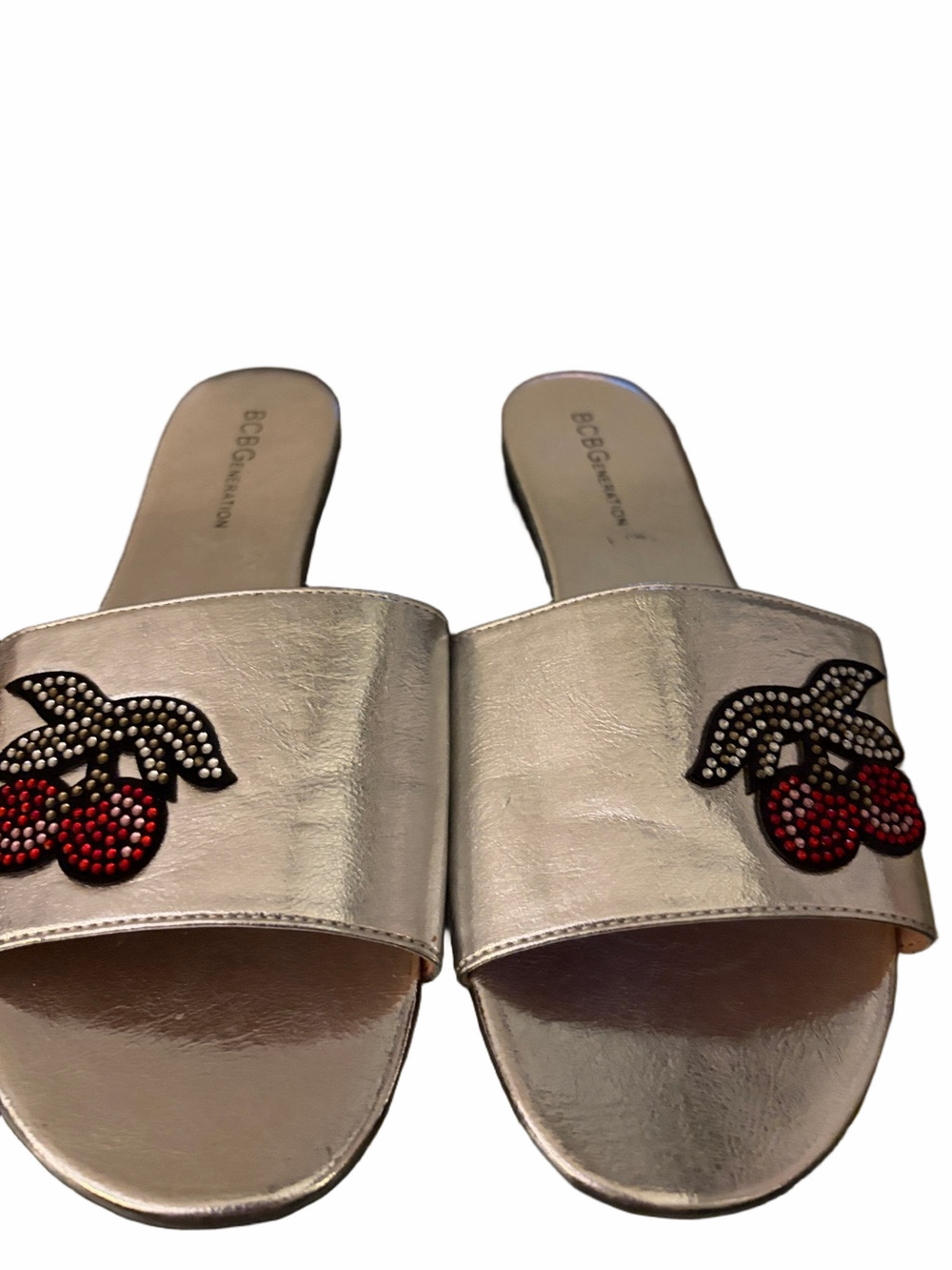 BCBG Silver Gennie slip in flat sandals with jeweled cherry detail. Size 7.5